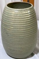 Full front view of the Westward ribbed stoneware vase showing oval shape and ribbed texture.