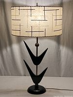 Full view of lamp lit showing base and shade