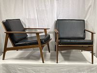 Front view showing both matching armchairs with cushions
