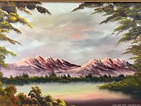 Close-up of the painted mountain landscape showing detailed pink mountain peaks, sky, lake, and surrounding foliage.