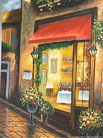 Close-up of the canvas print showing the cafe front with red awning, textured paint embellishments on the print surface.