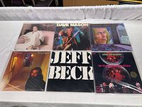Six vintage vinyl albums displayed together on a table, showing all front covers.