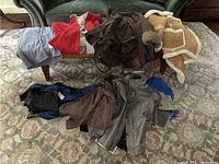 Overview of all seven coats and jackets on bench and floor