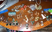 Overview of mixed costume jewelry items spread on wooden surface