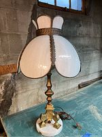 Full view of lamp showing white slag glass shade, brass-tone column and white marble base