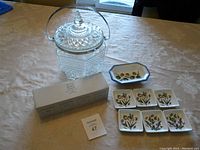 Photo showing the entire lot on a table: vintage glass cookie jar, Williams Sonoma olive dish, 6 Portmeirion Botanic Garden condiment dishes, 4 Keith Brymer Jones egg cups/condiment dishes, and original box for the egg cups.