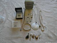 Full view of jewelry lot including various pendants, rings, bracelets, necklaces and earrings.