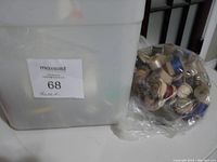 Large plastic container labeled with auction lot information, showing container size and contents.