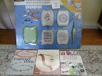 Front view of Fiskars Wire Winding Kit in packaging with molds and tools visible, along with three jewelry-making books laid out below.