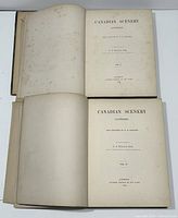 Two open volumes showing title pages for Volume I and Volume II of Canadian Scenery Illustrated by N.P. Willis and W.H. Bartlett, 1842.
