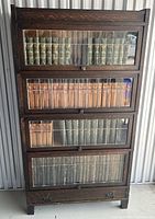 Front view of bookcase filled with books, compartments closed