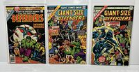 Three Marvel Defenders comic books displayed side by side in protective sleeves, front covers visible.