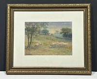 Framed watercolour depicting sheep grazing on a hillside within decorative gold-tone frame