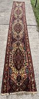Full length view of the vintage wool carpet runner showing its overall condition and pattern.