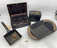 Front view of all items including the spice box, bread tin, tole pan, and painted tin, showing their colors and shapes.