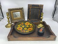 Overview of all items in the lot including frames, candlesticks, plate, trinket box, and tray