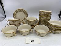 Set of Lenox Castle Garden salad bowls, soup bowls, and saucers with cream background, gold trim, and floral detailing