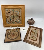 Overall view of the three sand paintings and small decorative gourd together.