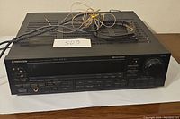 Front and top view of the black Pioneer VSX-5300 receiver with visible wiring on top.