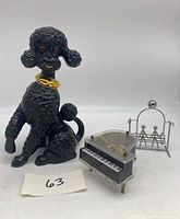 Photo showing all three items: black ceramic poodle figurine, Otagiri piano music player, and balancing swing sculpture.