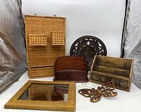 Full view of all items including rattan organizer with pockets, leather letter holder, wooden letter holder, carved wooden plate, butterfly decor, and rattan mirror.