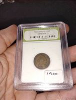 Front view of the certified 1900 Indian Head penny in slab showing certification label and coin obverse with Indian Head design.