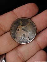 Reverse side of the 1900 Victorian penny showing seated Britannia with trident and shield, date below and denomination 'One Penny'.