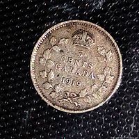 Obverse side of the 1919 Canadian 5 Cent coin showing crown and maple leaf wreath design with denomination and year.