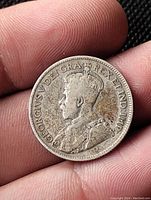 Obverse side of the 1933 Canadian 25 cent silver coin showing King George V's portrait and inscriptions.