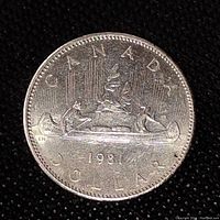 Reverse side of 1981 Canadian one dollar coin showing canoe scene, 'CANADA DOLLAR' text, and year '1981'.