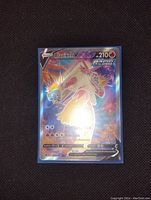 Photo showing full front of Blaziken V full art holographic Pokémon card with vibrant colors and clear text.