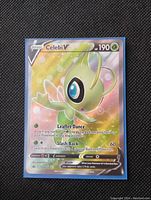 Front photo of Celebi V Pokémon card showing full art holo foil and details including HP, attacks, and illustration.