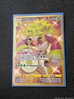 Front view of Gold Rillaboom full art holographic glitter Pokémon card, showing character, attacks, HP, and holographic foil effect.