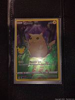 Front view of the holo foil Pikachu Pokémon card showing purple ears and card details.