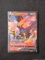 Close-up image of Talonflame V full art foil card showing details of the artwork, HP, and attacks.