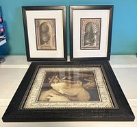 Set of three framed art prints displayed together on a flat surface with two vertical prints behind one larger square print in front.
