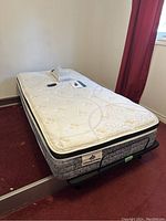 Full view of single mattress on adjustable base in room