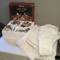 Image showing the boxed village set in original packaging with white snow fabric pieces next to it.