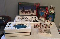 Full view of the Thanksgiving table with 30-piece accessory set in original styrofoam trays, multiple boxed items in background.