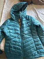 Front full view of teal Columbia jacket showing hood and zippered front.