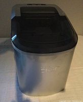 Frontal view showing the silver portable ice maker with Master Chef branding and black tinted lid.