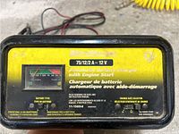 Front view showing MotorMaster label, 75/12/2A 12V, automatic battery charger with engine start, condition details visible