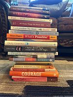 Stack of self-help books showing various titles and authors.