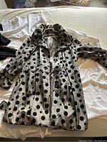 Front view of Casa Donna polka dot jacket showing silver-tone fabric with large black dots, button closure, collar, and gathered waist detail.