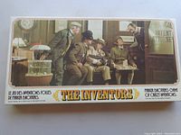 Box cover featuring vintage style illustration of men at office patent attorney setting.