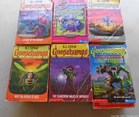 Six Goosebumps books with illustrated covers including Attack of the Mutant, The Scarecrow Walks at Midnight, and Series 2000 Invasion of the Body Squeezers part 1