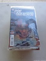 Stack of Star Wars comics led by Marvel Poe Dameron issue #1 enclosed in protective plastic.