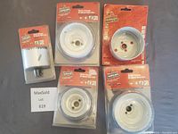 Five brand new Vermont American bi-metal hole saws in packaging showing different diameters and quick change designs.