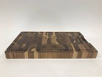 Side view showing thickness and wood blocks of butcher block cutting board.