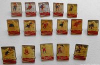 Photo showing 16 Coca-Cola pins from the Calgary 1988 Winter Olympics. Pins illustrate various winter sports athletes on a gold-tone background with red Coca-Cola banner and Calgary 88 inscription.